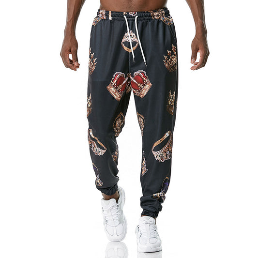 Black jogger pants with graphic designs worn by a person on a white background