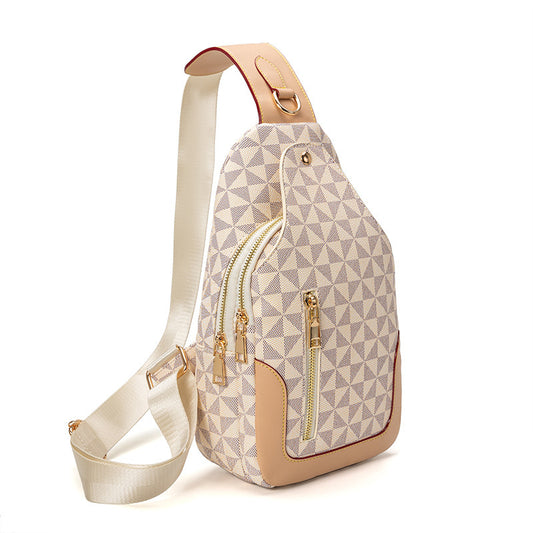 Sling bag with geometric pattern and gold zippers on a white background