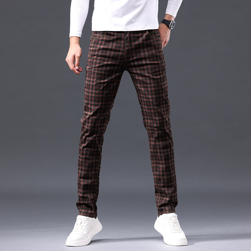 Person wearing brown plaid pants on a gray background