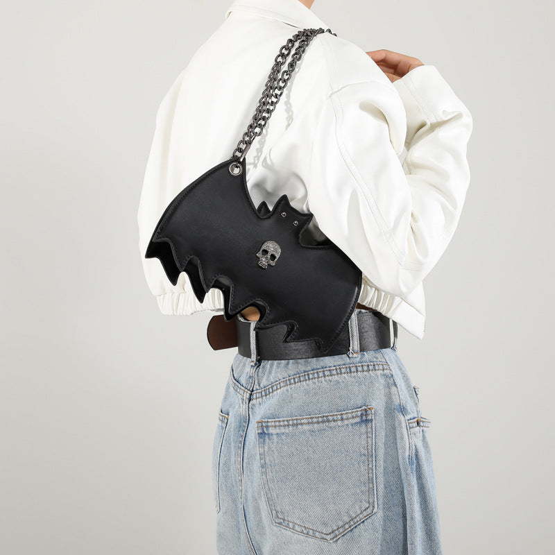 Handbag shaped as a bat on a white background.