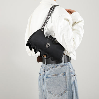 Handbag shaped as a bat on a white background.
