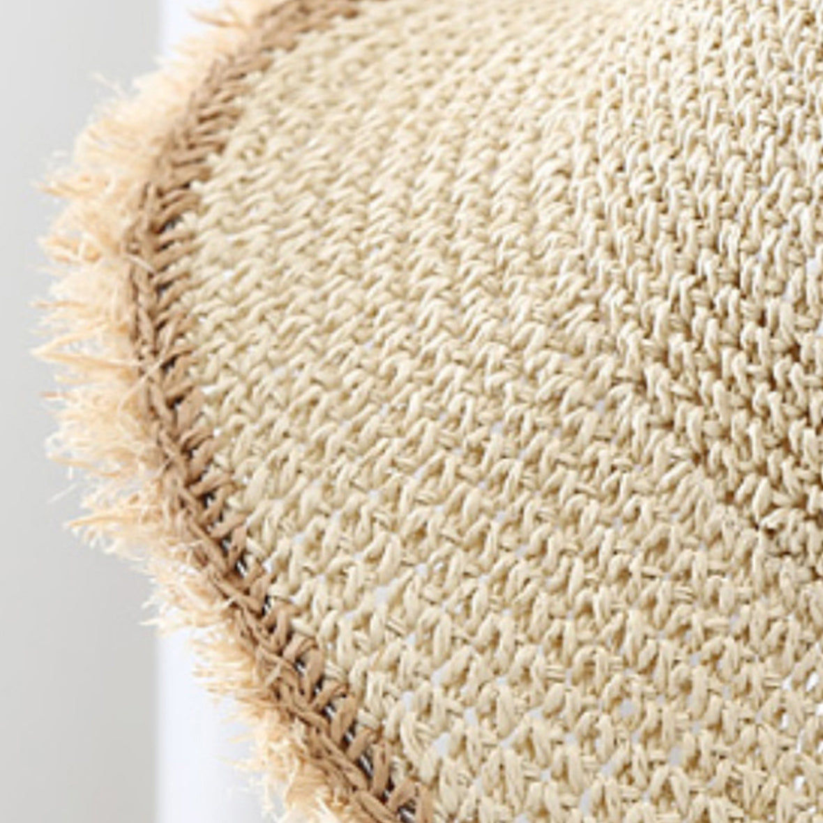Close-up of a textured beige rug with a white background