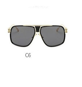 Sunglasses with gold frame and dark lenses on a white background