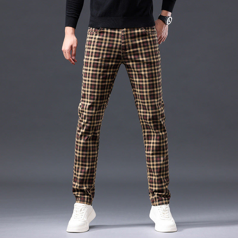 Person wearing plaid pants on a gray background