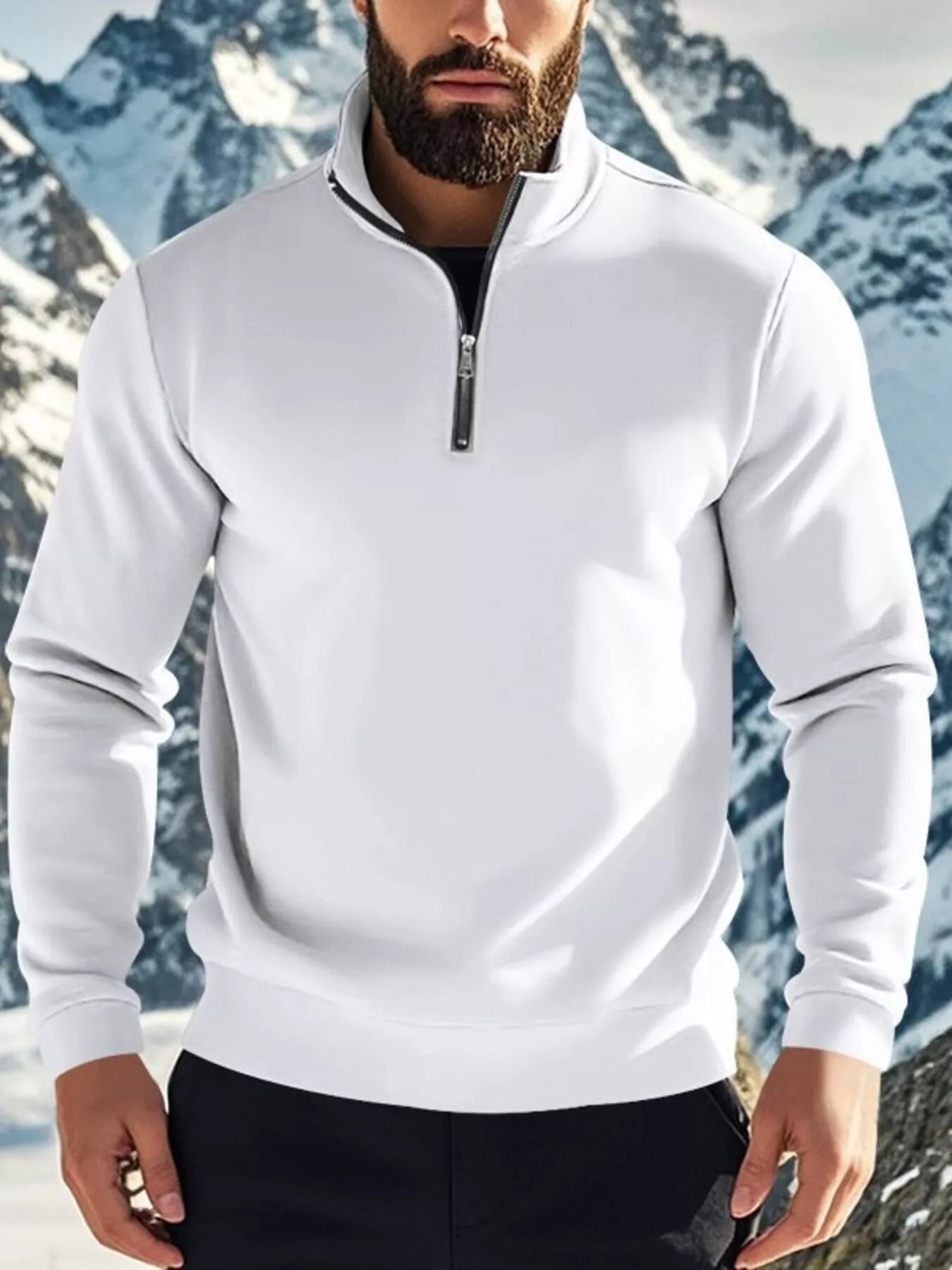 Person wearing a white quarter-zip sweatshirt with a mountainous background