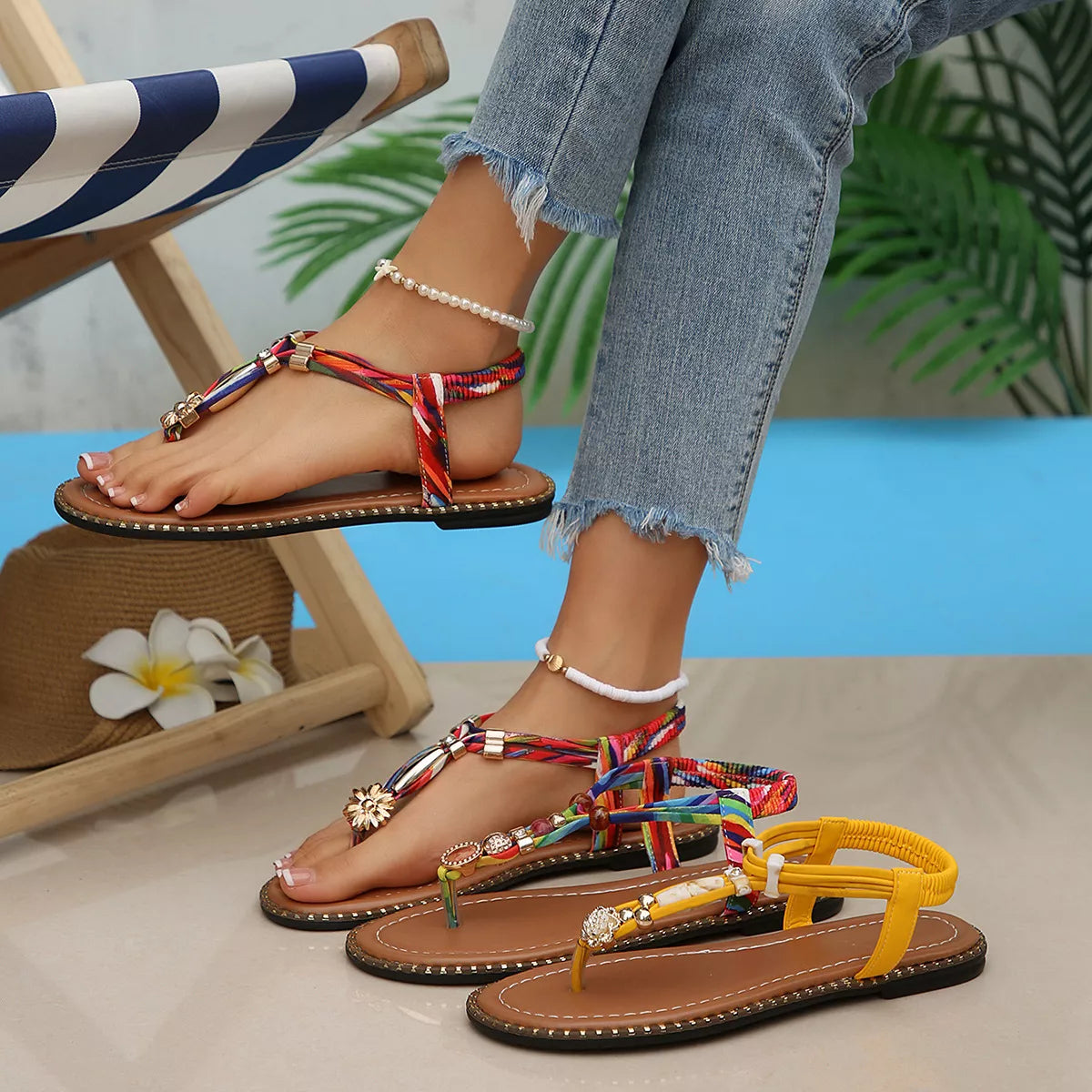 Colorful sandals worn with denim jeans on a neutral background