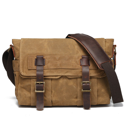 Brown leather messenger bag with a white background