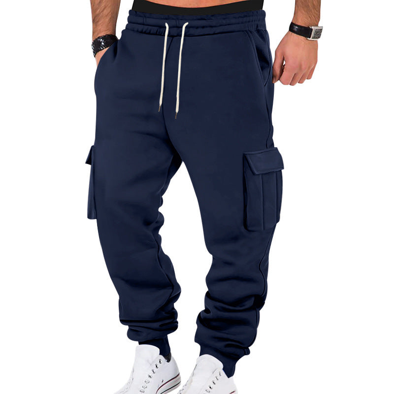Navy blue cargo jogger pants worn by a person on a white background