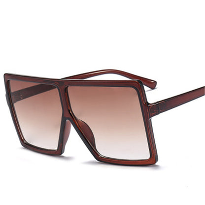 Brown sunglasses with a gradient lens on a white background