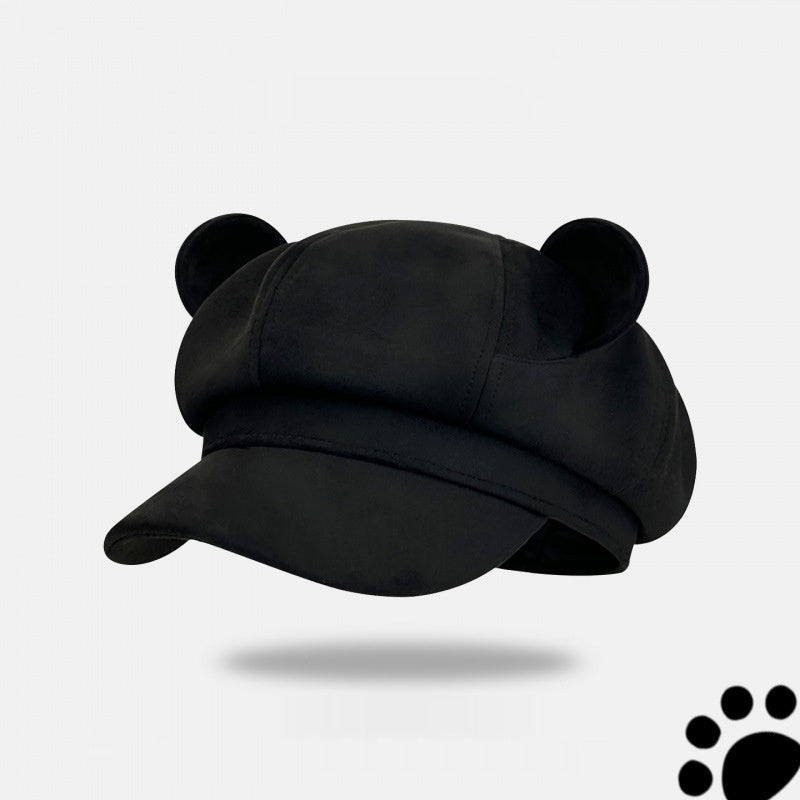 Black cap with bear ears on a light gray background