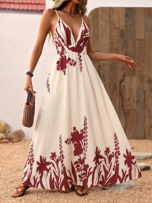 Woman wearing a white dress with red floral patterns on a sandy background