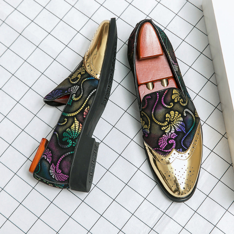 Pair of ornate loafers with floral patterns on a grid background