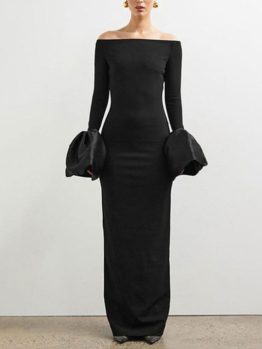 Black off-shoulder dress with long sleeves on a plain background