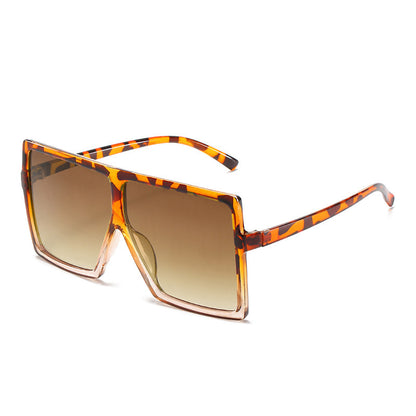 Sunglasses with tortoiseshell frame and brown lenses on a white background