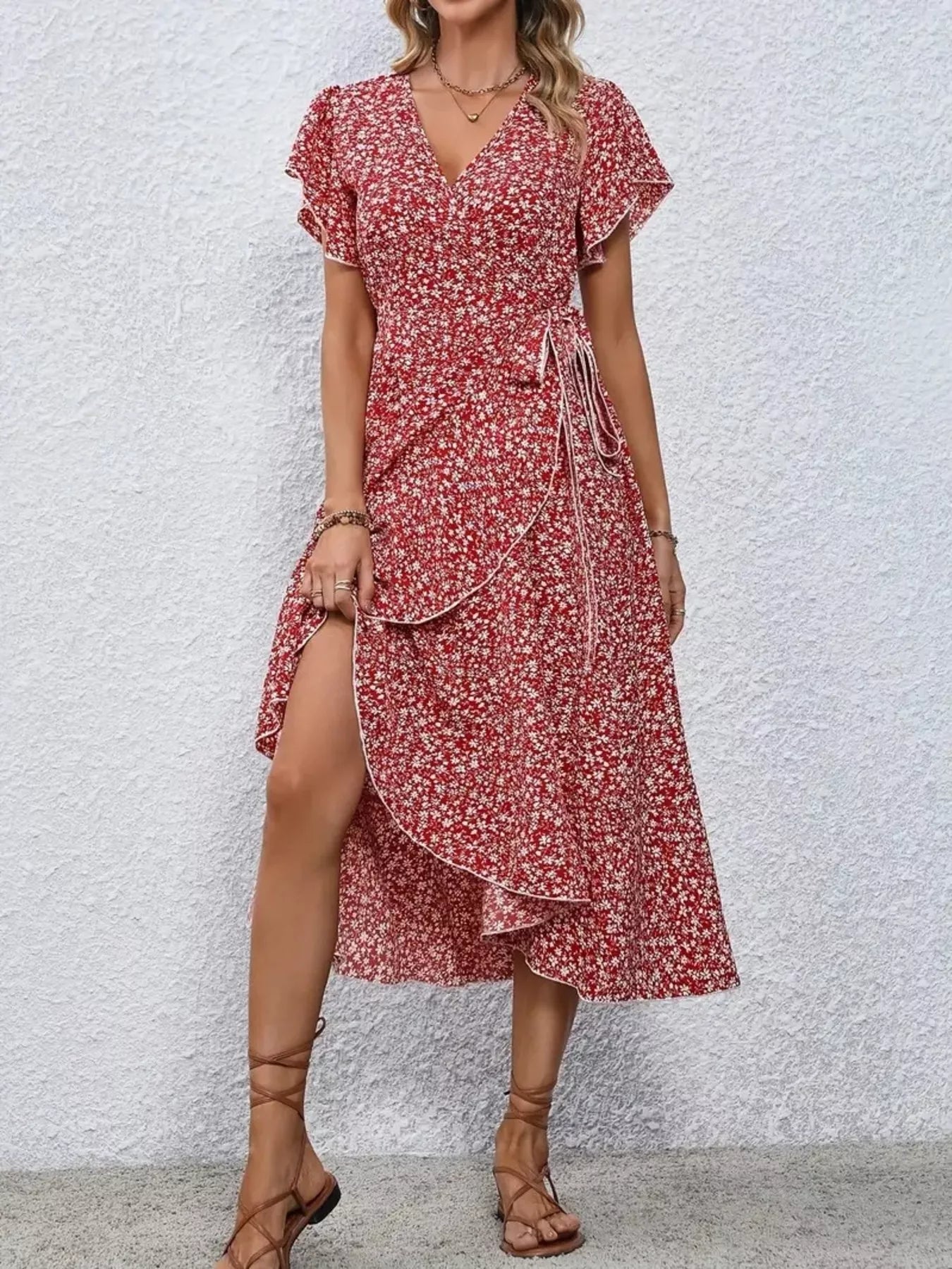 Woman wearing a red floral dress with a white background