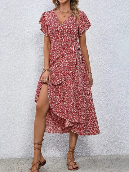 Woman wearing a red floral dress with a white background