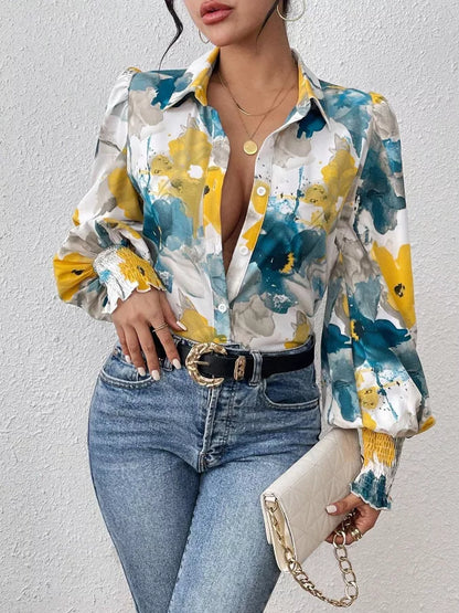 Woman wearing a colorful floral blouse and jeans against a white background