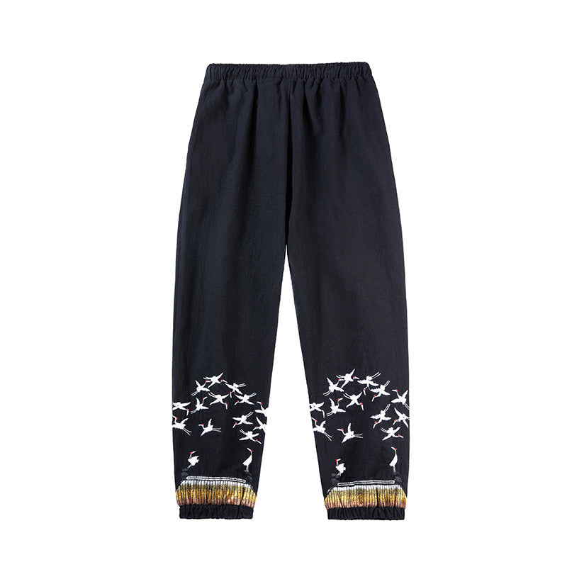 Black pants with white bird patterns on a white background