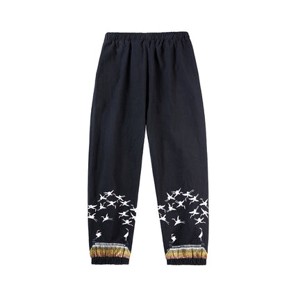 Black pants with white bird patterns on a white background