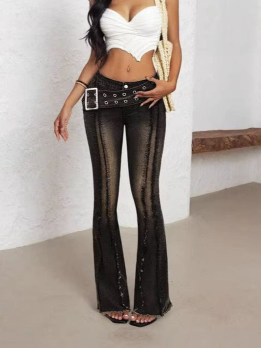 Woman wearing black sheer flared pants with a white top against a plain background