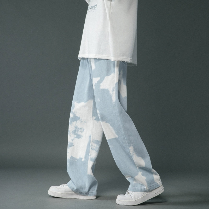 Light blue and white tie-dye pants worn by a person on a gray background