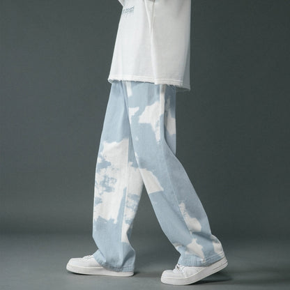 Light blue and white tie-dye pants worn by a person on a gray background