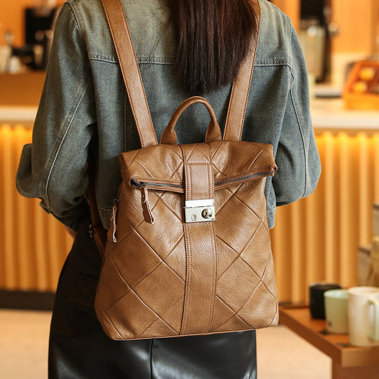 Stylish backpack with zipper and fasten details being worn.