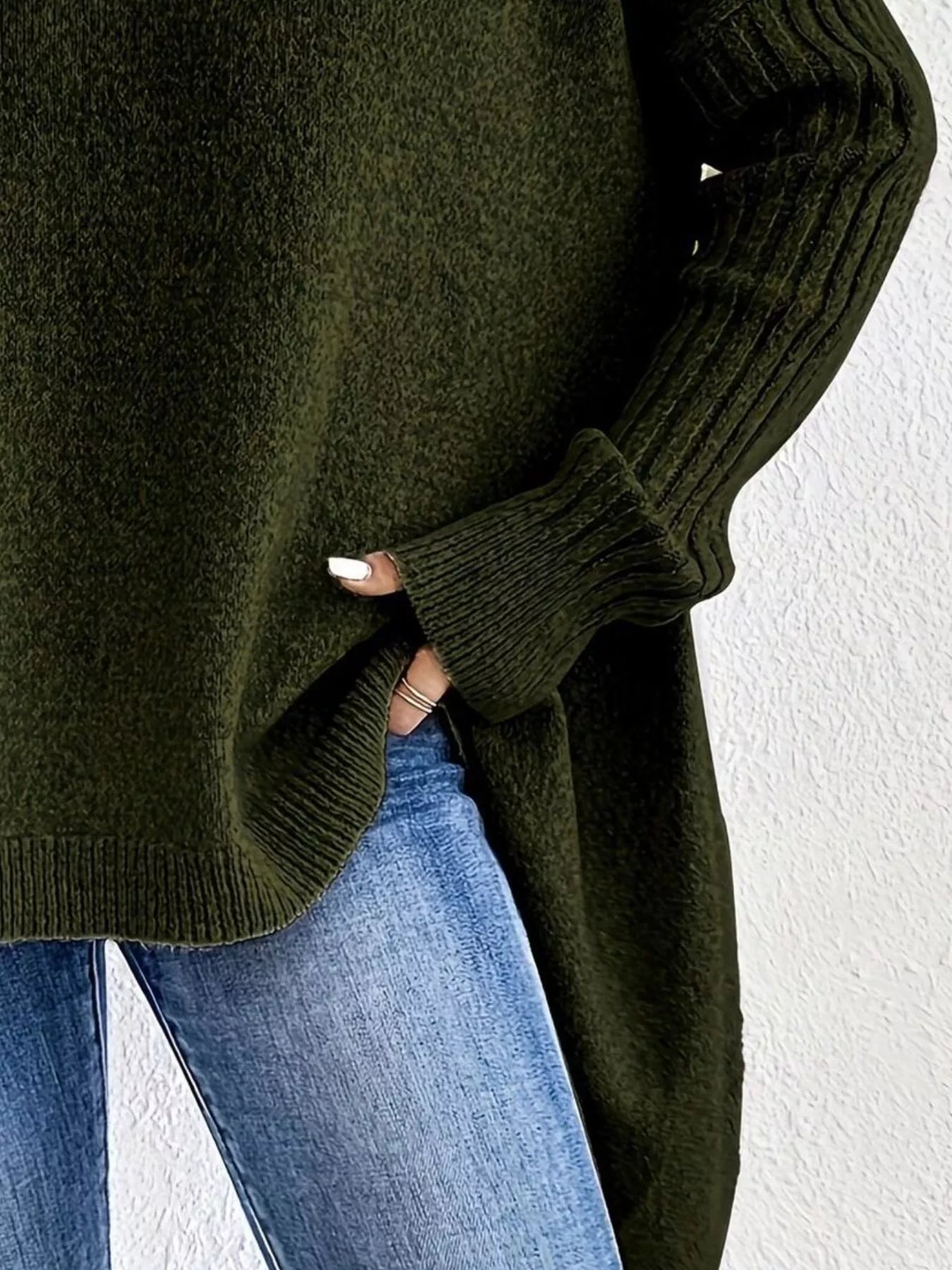 Green sweater worn by a person with a white background