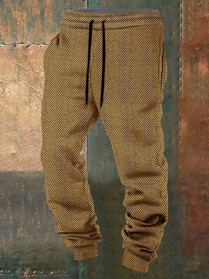 Brown herringbone-patterned jogger pants on a textured surface