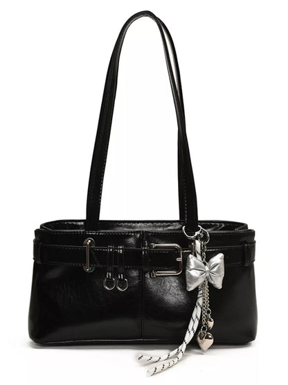 Black handbag with a decorative bow charm on a white background