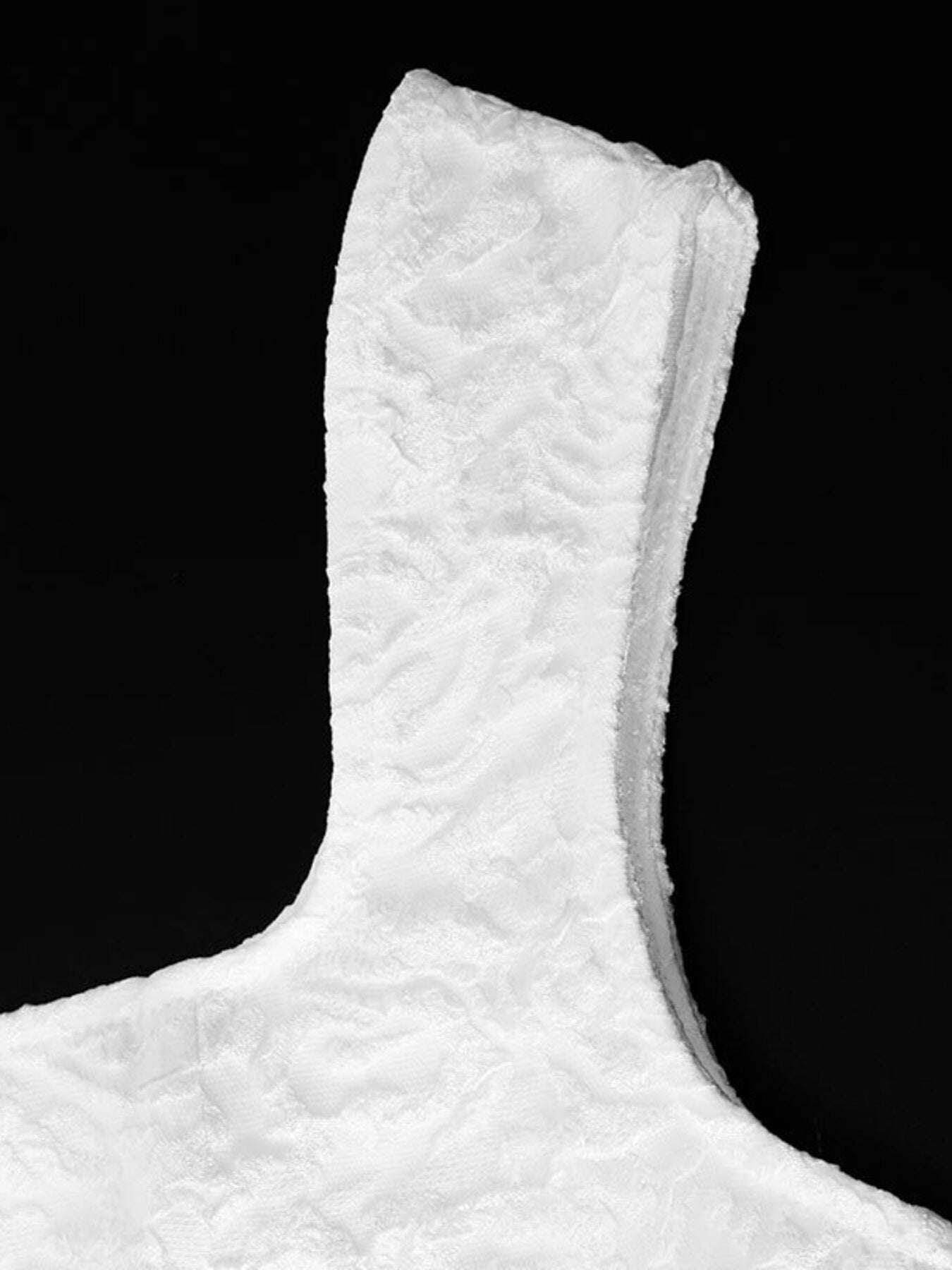 Close-up of a textured white object against a black background