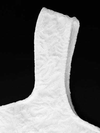 Close-up of a textured white object against a black background