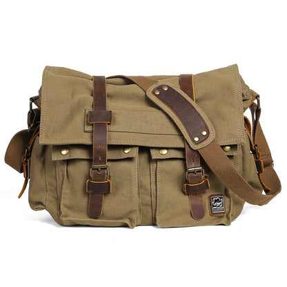Green canvas messenger bag with brown leather straps on a white background