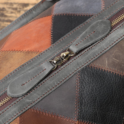 Close-up of a patchwork leather bag with a zipper.