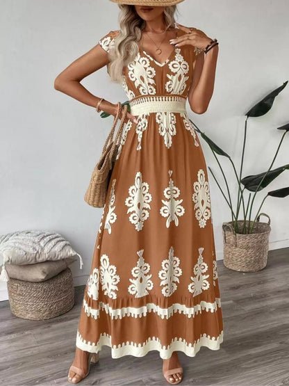 Woman wearing a brown dress with white lace patterns in a room.