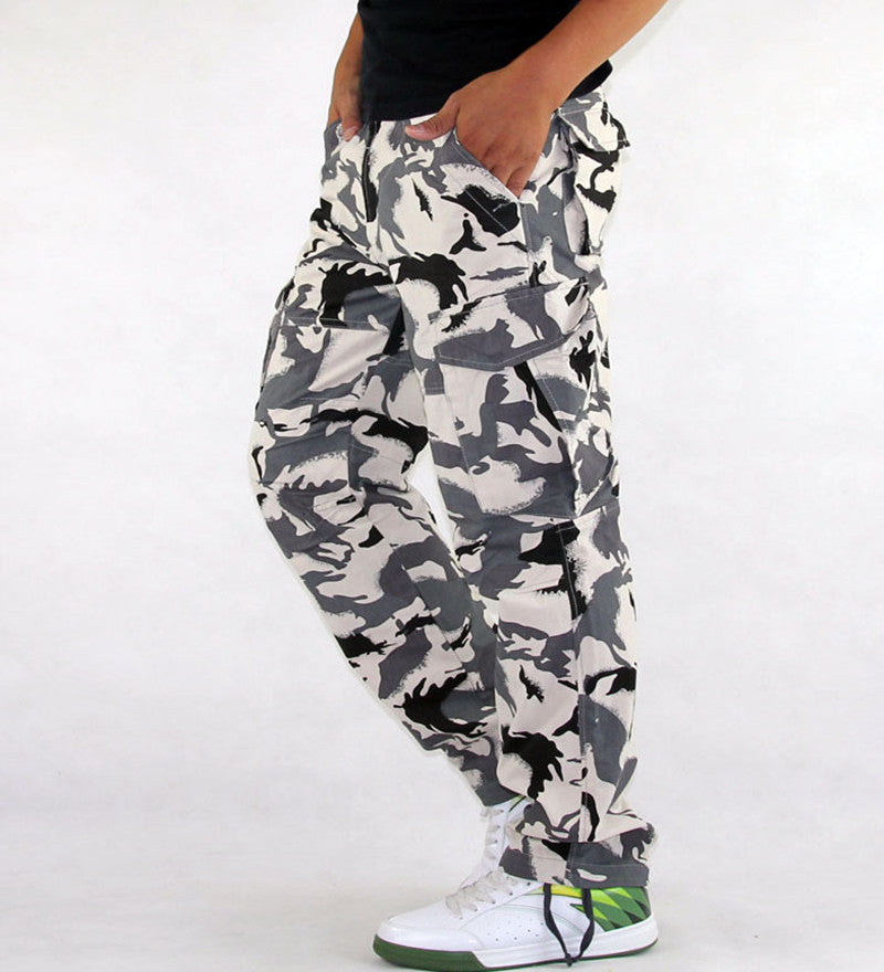 Camouflage pants worn by a person on a white background