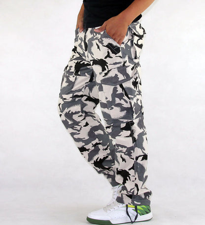 Camouflage pants worn by a person on a white background