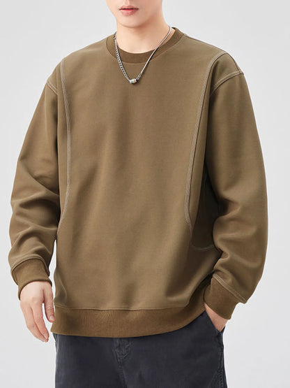 Person wearing a brown sweatshirt on a white background