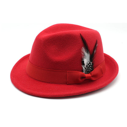 Red fedora hat with a feather bow on a white background