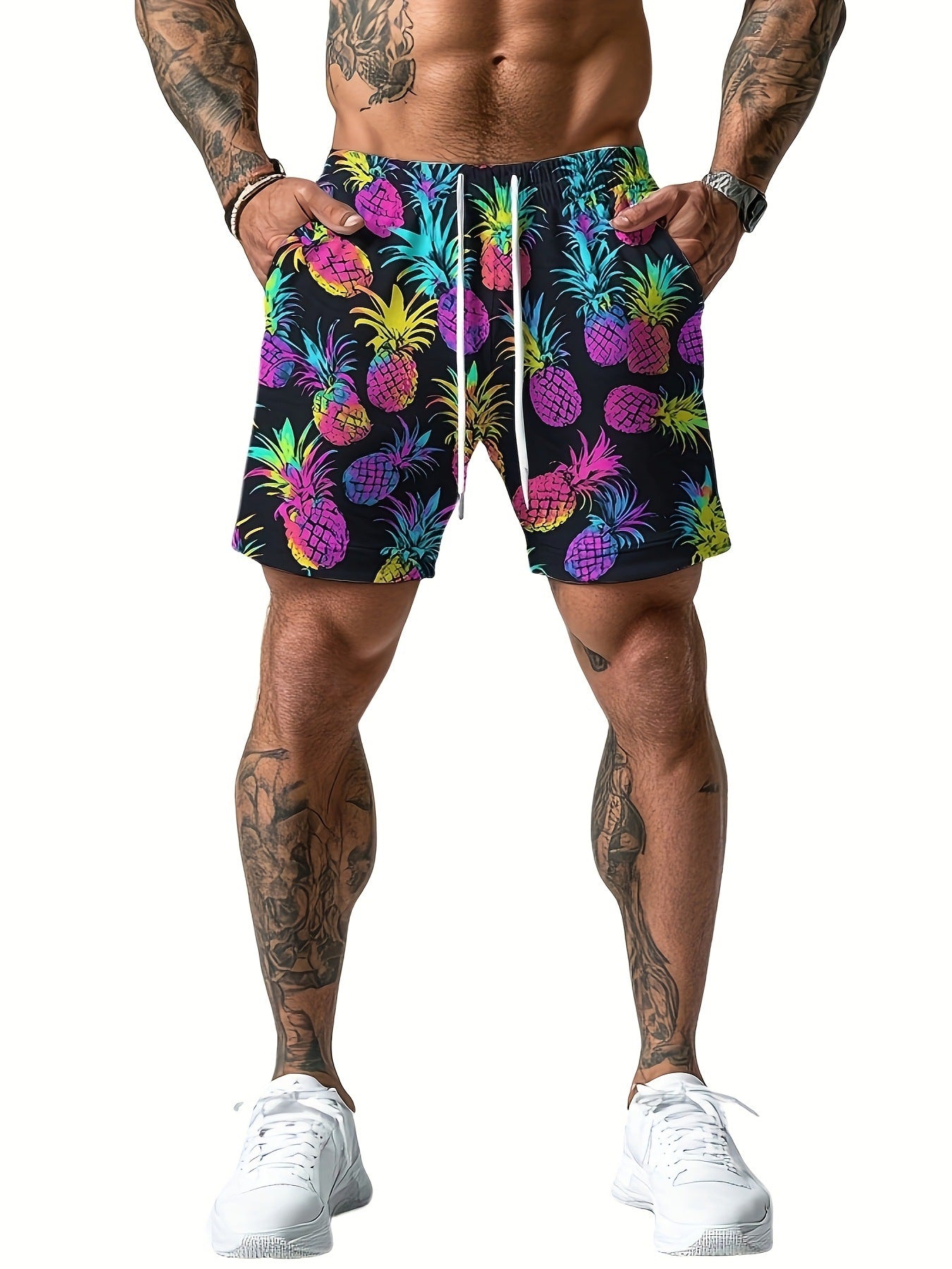 Person wearing colorful pineapple-patterned shorts on a white background