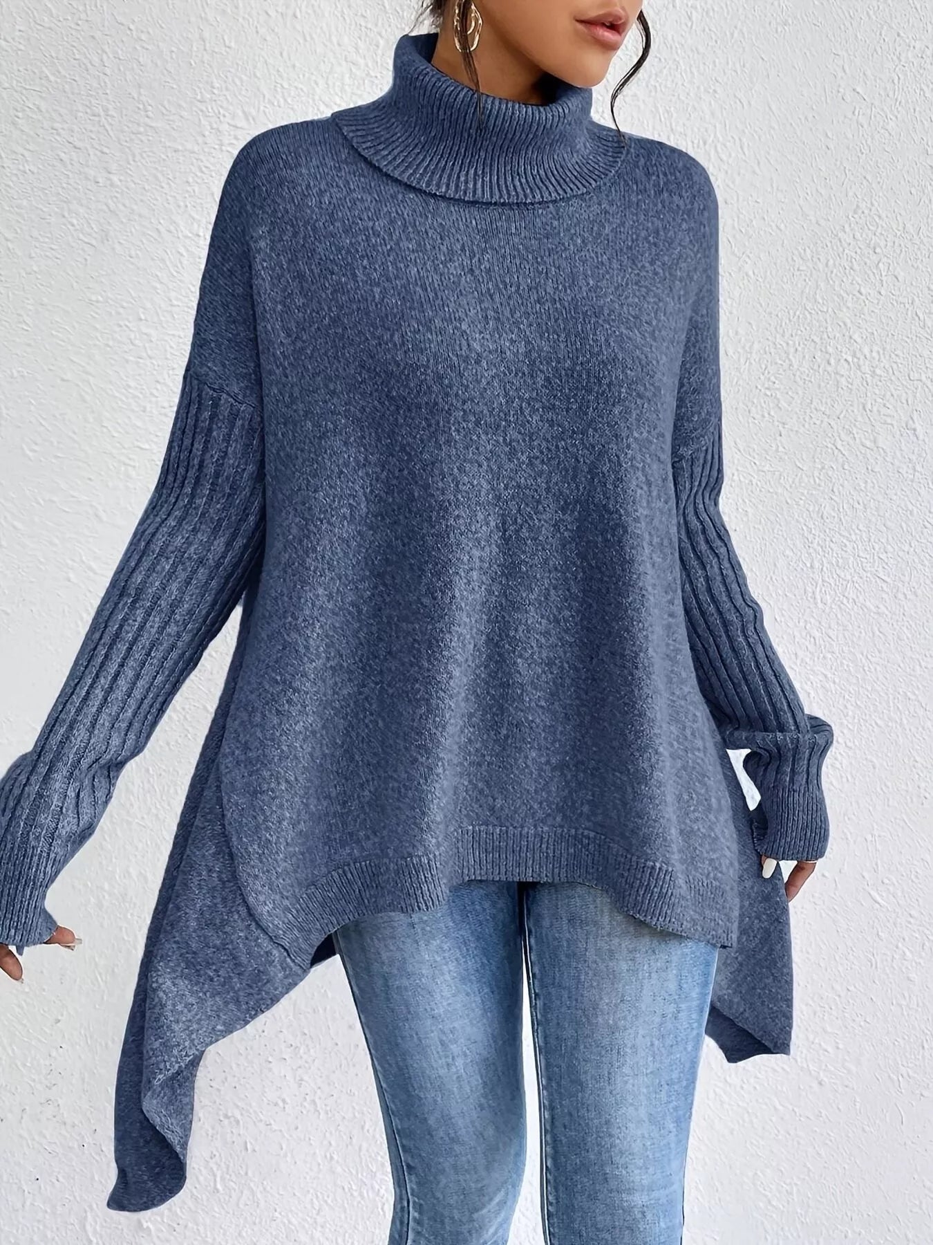 Person wearing a blue sweater with a white background
