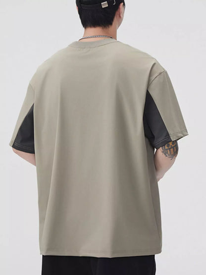 Person wearing a beige and black sleeveless shirt on a white background