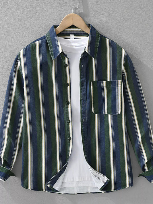 Striped shirt on a hanger against a gray background
