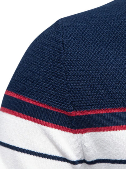 Close-up of a navy blue, white, and red striped shirt sleeve on a white background