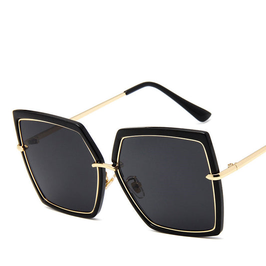 Sunglasses with black lenses and gold frames on a white background