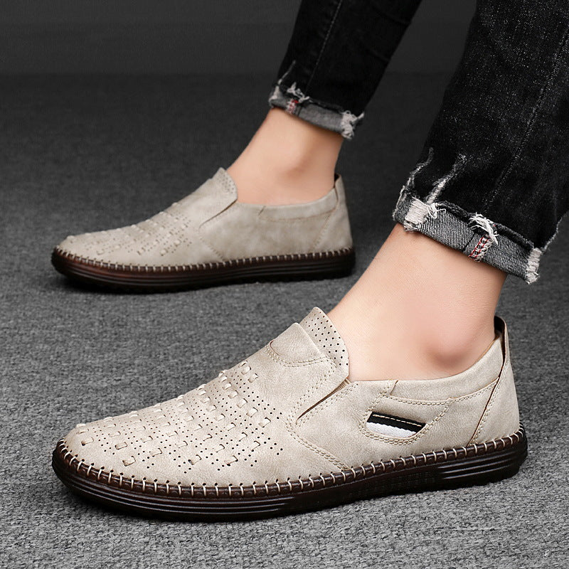 Gray casual shoes worn with dark jeans on a gray background