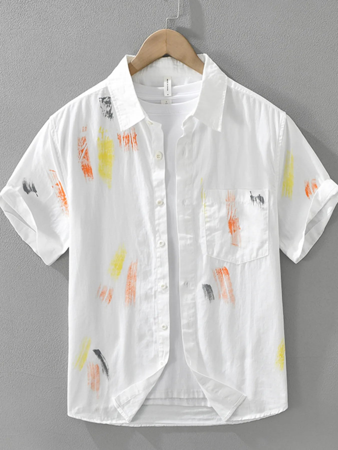 White shirt with colorful abstract patterns on a gray background