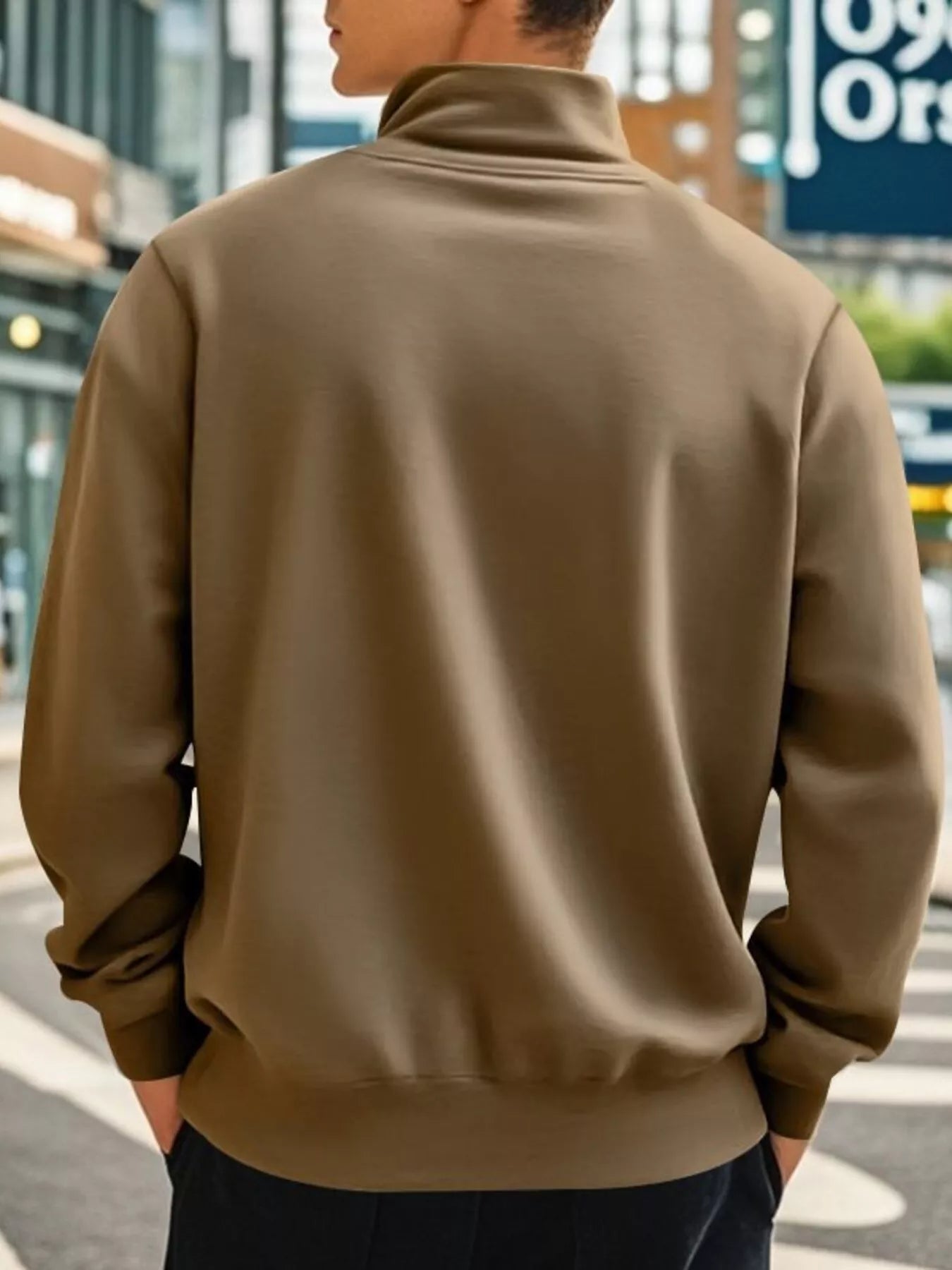Person wearing a brown jacket on a city street