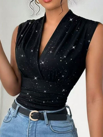 Black sleeveless top with star pattern worn by a person, against a neutral background