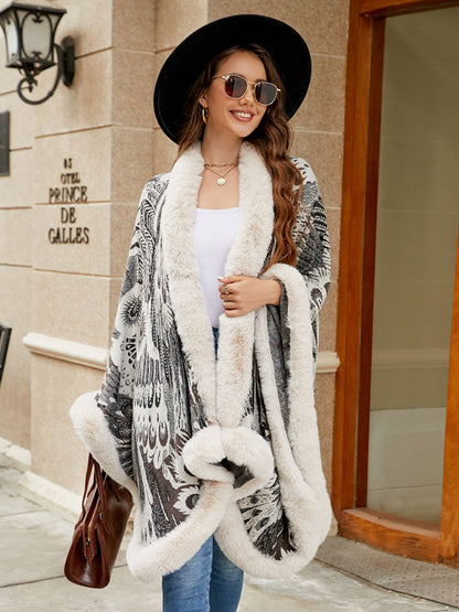 Woman wearing a stylish coat with fur trim in front of a building.